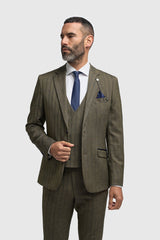Man wearing a brown checkered suit with a blue tie on a white background