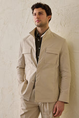 Beige smart casual tweedelig pak voor heren in safaristijl met opstaande kraag en stretchstof.