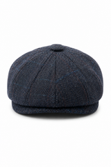 Herenpet in marineblauwe wollen tweedstof, model newsboy.