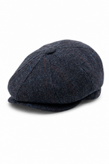 Herenpet in marineblauwe wollen tweedstof, model newsboy.