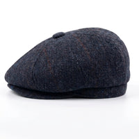 Herenpet in marineblauwe wollen tweedstof, model newsboy.