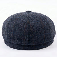 Herenpet in marineblauwe wollen tweedstof, model newsboy.